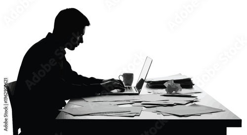 Profile silhouette of a serious man diligently typing on his laptop at a cluttered desk