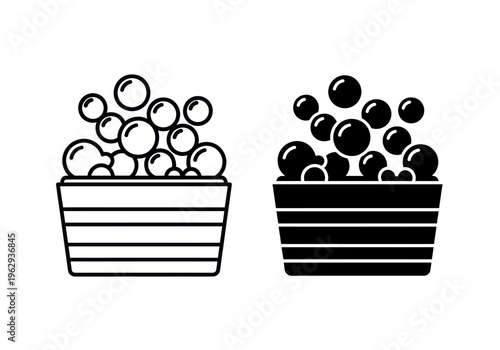 Two striped buckets filled with shiny balls on display side by side