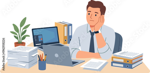 Businessman sits at desk with laptop and books looking bored