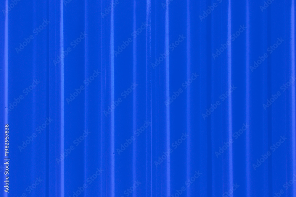 Fototapeta premium Abstract ribbed smooth deep blue striped plastic pattern or texture as background