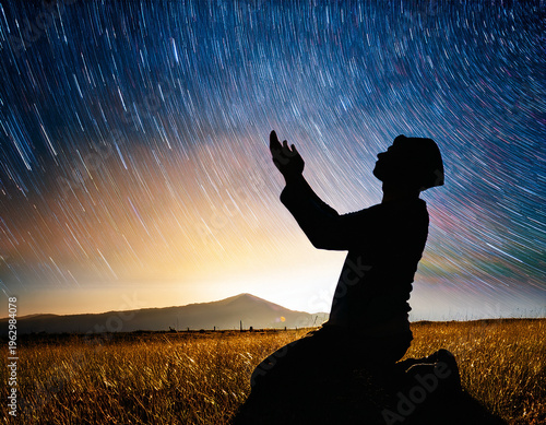 Man Under Milky Way Galaxy at Sunset Experiencing praying to God in Open Landscape