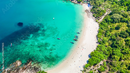 Stunning aerial view of the beach. An aerial photograph of the beautiful tropical beach and sea on Phuket Island. Located at Freedom Beach, Phuket, Thailand, at 10 am – the start of sunbathing, summer