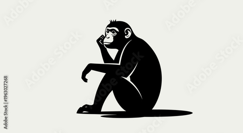 Silhouette of a thoughtful chimpanzee sitting in a pensive pose.