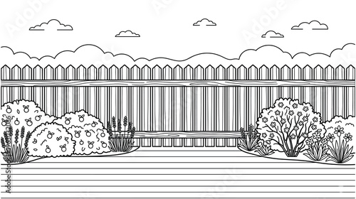 Backyard garden scene with wooden fence and flowering bushes.