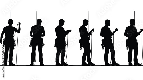 Silhouettes of rock climbers ascending a wall focused on their physical exertion and gear