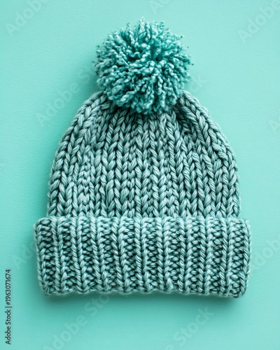 Soft Knit Hat with Pom Pom in Cool Turquoise on Solid Background