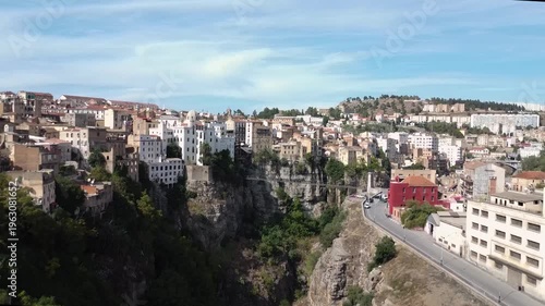 Panoramic aerial view of the historic cliffside city of Constantine, Algeria, featuring traditional architecture perched over the Rhumel River gorge.