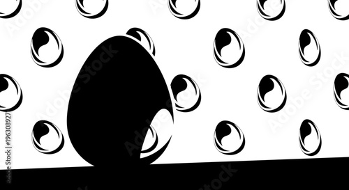 Large black egg stands prominently in a stark, high-contrast setting.