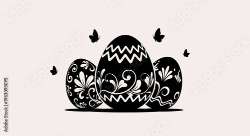 Three decorative black Easter eggs with intricate patterns and butterflies.