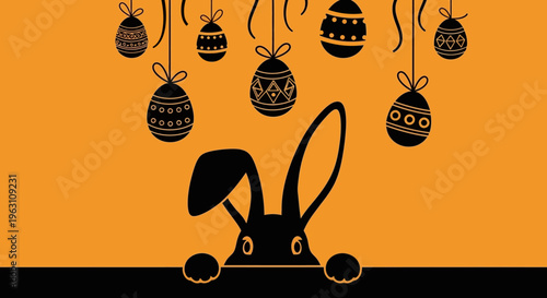 Black Easter bunny peeking with decorated eggs hanging above.