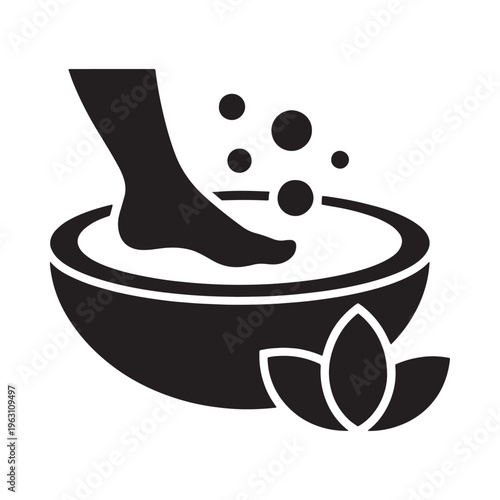 Foot soaking in a bowl with bubbles and floral decoration
