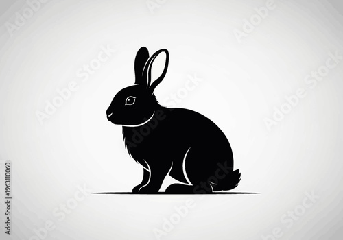 A black silhouette of a rabbit sits calmly in a simple vector style side view