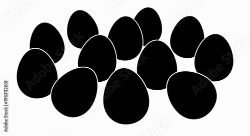 A dozen black eggs arranged in a scattered group.