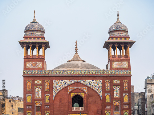 Cityscape view of entrance gate or portal of ancient Wazir Khan mosque with kashi-kari decor, Lahore, Punjab, Pakistan