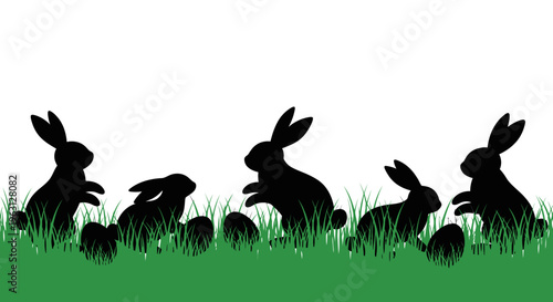 Silhouettes of Easter bunnies and eggs in green grass.