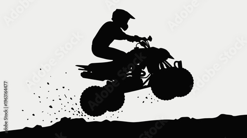 Silhouette of an ATV rider jumping over a dirt hill with dirt flying.