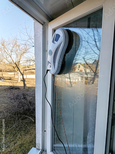A window cleaning robot at work. A window being washed by a window cleaning robot.