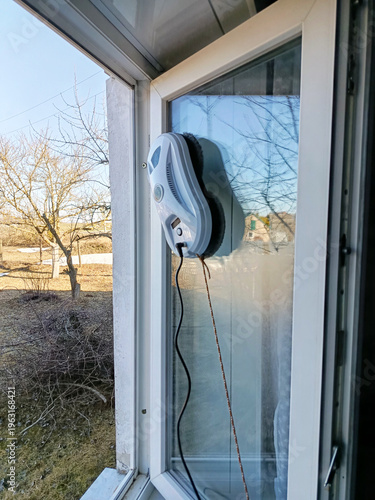 A window cleaning robot at work. A window being washed by a window cleaning robot.