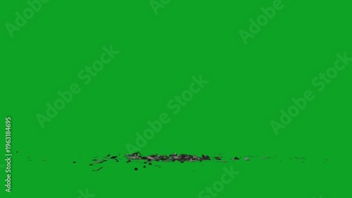 Broken black ceramic plate shattering on green screen floor in slow motion effect