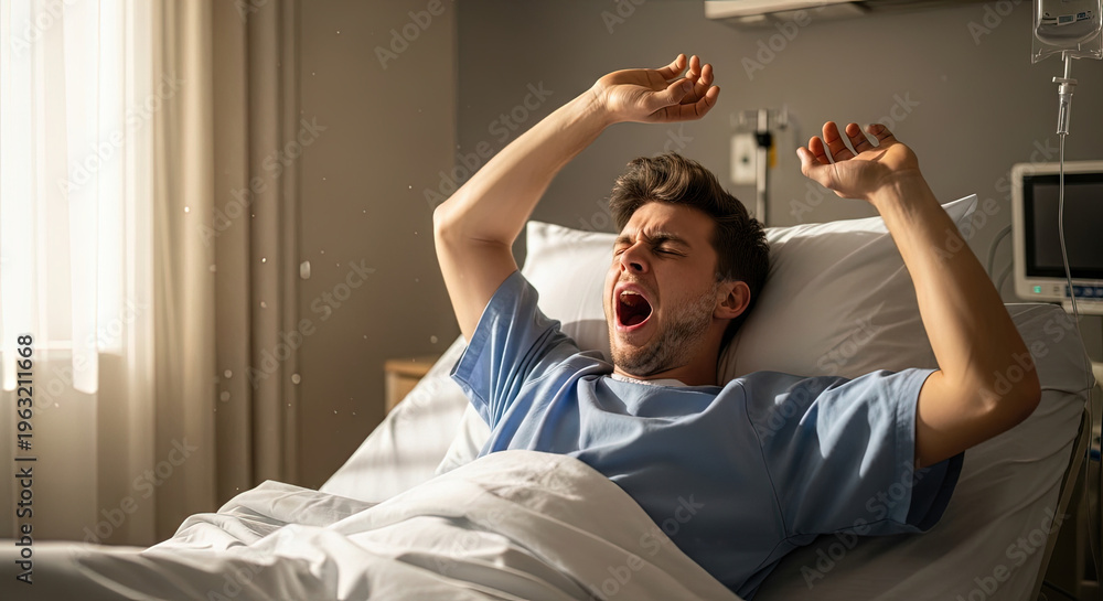 Obraz premium Young man yawning in hospital bed while stretching his arms 