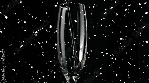 Animation of confetti over glass of champagne