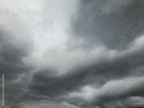 Dramatic dark storm clouds background, moody overcast sky, heavy grey rain clouds, atmosphere before the storm, nature weather photography
