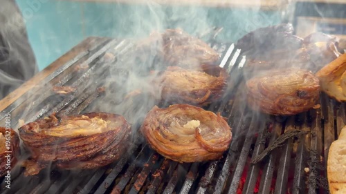 Kokorec, a traditional Turkish dish made from offal, is cooked on a grill.