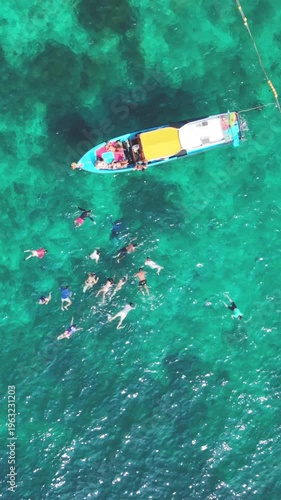  Vertical Top Down Aerial View of Longtail Boat and Snorkelers Ko Tao Thailand