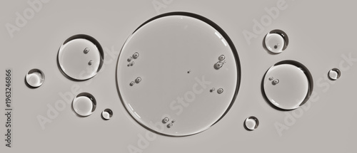 Transparent cosmetic serum gel drops isolated on a light grey background illustrating hydration and skin care concepts for dermatology brand packaging design advertising layouts and visual templates