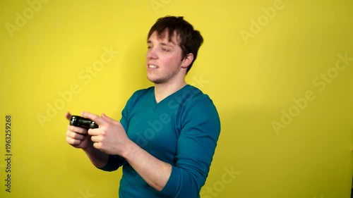 A man plays the console, video games react strongly and emotionally while sitting on the couch.