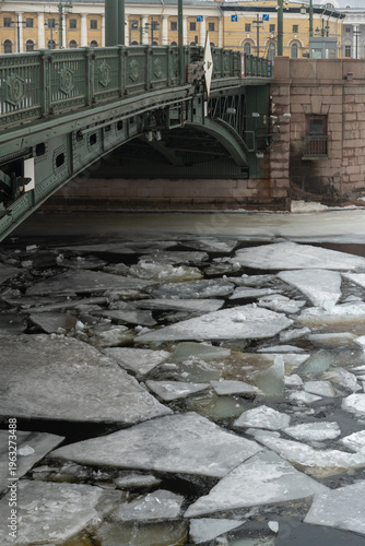 Winter in Saint Petersburg shows a bridge over ice-covered water
