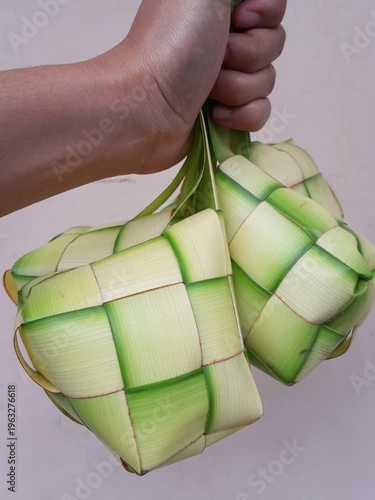 A small rice cake boiled in a pouch of woven palm leaves, originating in Indonesia. (Ketupat)