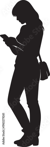 A woman standing while looking down at her mobile phone