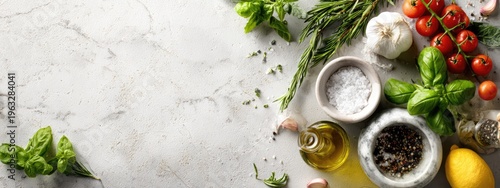 Overhead view of fresh ingredients for cooking, including herbs, tomatoes, garlic, salt, pepper, and lemon on a marble surface.