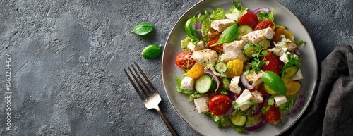 Fresh Chicken Salad with Tomatoes, Cucumbers, and Basil on a Rustic Table.
