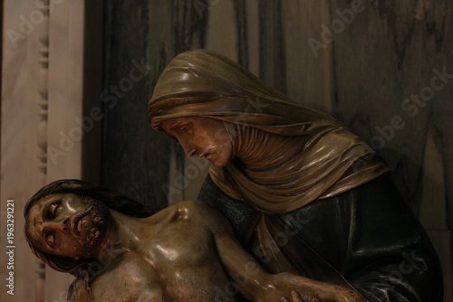 Obraz na plátně Pietà sculpture, Virgin Mary holding Jesus Christ, religious art, baroque style, dramatic lighting, dark background