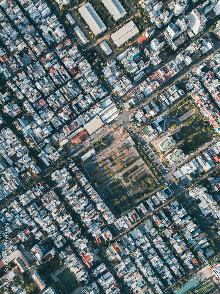Fototapeta premium Aerial top view of dense urban neighbourhood with grid streets and residential buildings, Drone perspective of city infrastructure and architecture pattern in Asian Danang city, Da Nang, Vietnam