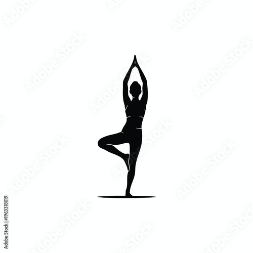 Silhouette of a woman in a yoga tree pose with hands raised above head