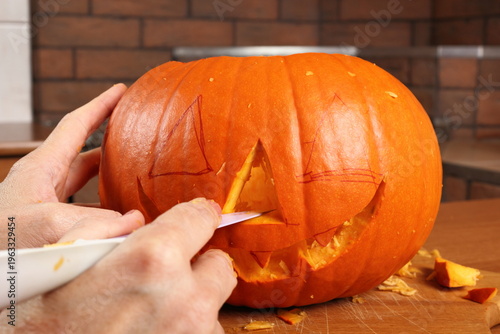 Making Jack o lantern. Carving the pumpkin.