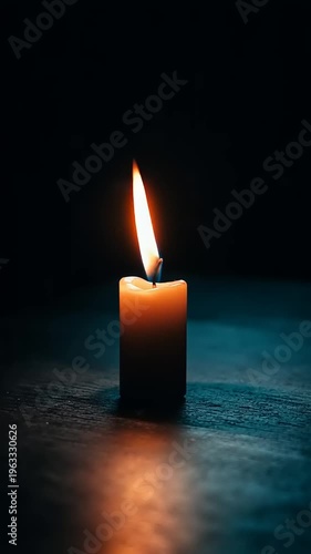 A single candle burns brightly alone.