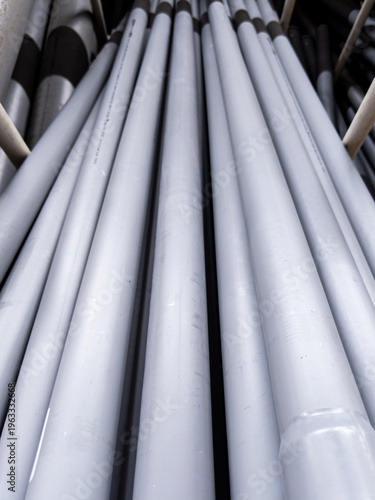 Fotografie Converging lines of smooth gray polymer tubes creating an abstract industrial ge