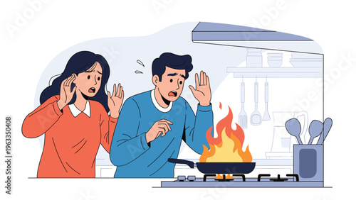 Panicked couple reacts with fear as a dangerous fire breaks out in a frying pan on a gas stove inside a modern domestic home kitchen.