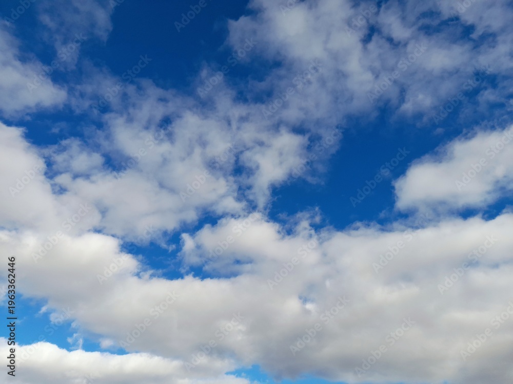 Obraz premium Beautiful bright blue sky with fluffy white cumulus clouds on a sunny day