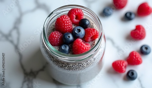 Layered parfait dessert with berries, yogurt, granola, and chia seed pudding, macro shot.