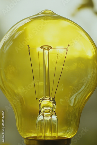 A single yellow light bulb placed on a table, great for indoor or studio use
