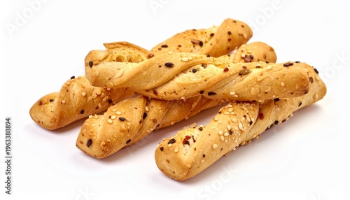 crispy baked twisted grissini breadsticks with sesame seeds piled isolated