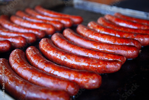 Meat sausages are grilled. Christmas market.