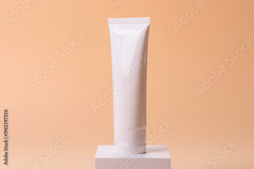 A white empty plastic or aluminum tube for cream, paste as a mockup. An empty cosmetic tube mockup