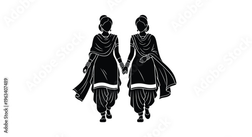 Two women in traditional indian attire walking and holding hands