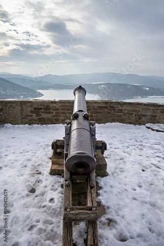 Photos Front View of Historic Castle Cannon Pointing Over Frozen Ederse